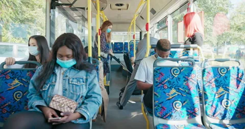 People are getting from the bus stop to the bus. An elderly man helps a Stock-Footage 174522810