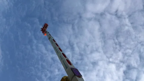 People are having fun on a flying chairs at amusement park in Paris city Video stock 131183456