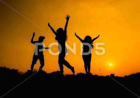 People are having fun in the garden on the silhouette. Stock Photos