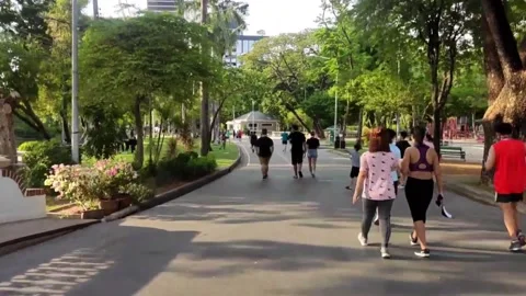 People are jogging in the evening after work in Bangkok Stock Footage
