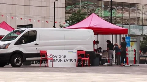 People are lining up to get a Covid-19 vaccine at the pop-up vaccine clinic Stock Footage 158946179