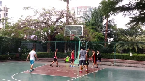 People are playing basketball during the National Day holiday Stock Footage