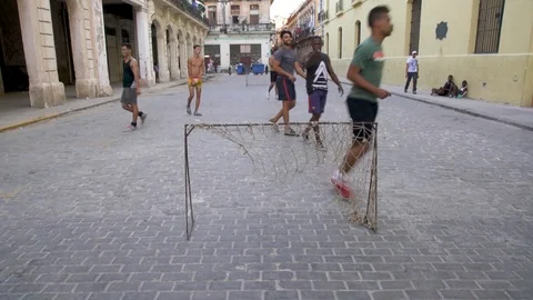 People are playing football in a street of Havana Cuba, 4K Stock Footage