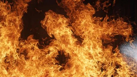 People are practicing fire extinguishers with water. Stock Photos
