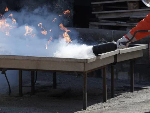 People are practicing fire extinguishers with water. Stock Photos