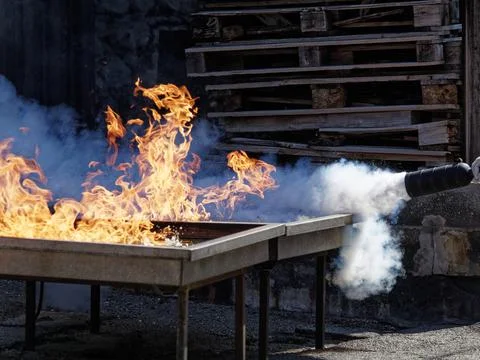 People are practicing fire extinguishers with water. Stock Photos