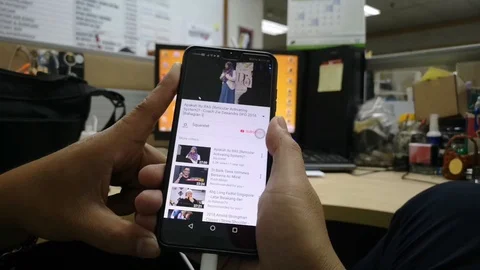 People are relaxing while browsing Youtube app on their mobile phone. Stock Footage 95876709