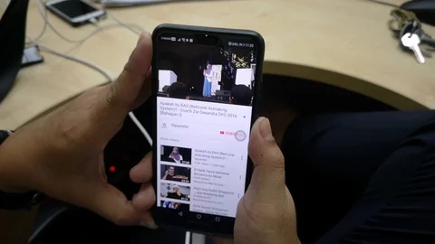 People are relaxing while browsing Youtube app on their mobile phone. Stock Footage 95876804