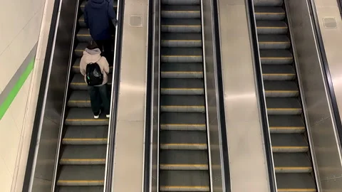 People are riding an escalator in an underground metro passage. Stock Footage 319695667