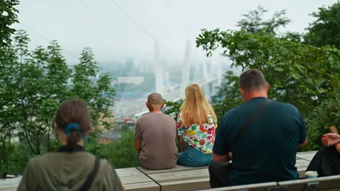 People are sitting on a bench at an observation point overlooking the bridg.. 動画素材 344458205