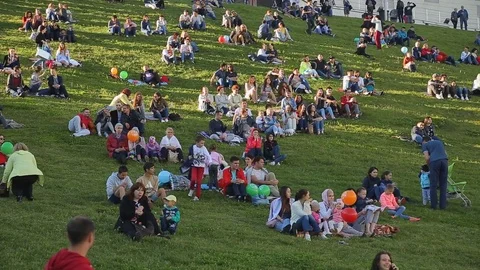People are sitting on the green grass and watching a movie. Festival Heart of Stock Footage 78986946
