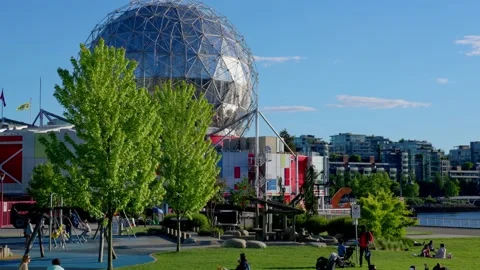 People are sitting in groups by the Science World, Vancouver, Canada, May 2021 Stock Footage 155082801
