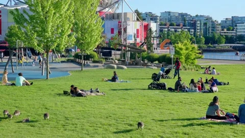 People are sitting in groups by the Science World, Vancouver, Canada, May 2021 Stock Footage 155082905