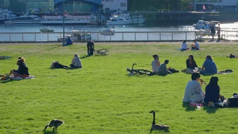 People are sitting in groups by the Science World, Vancouver, Canada, May 2021 Stock Footage 155082946