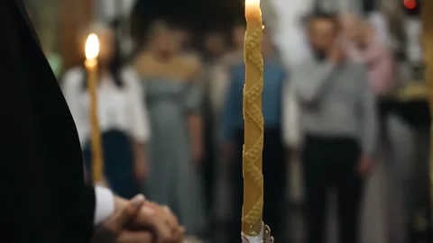 People are standing in the temple for prayer and holding long candles Stock Footage 301209867
