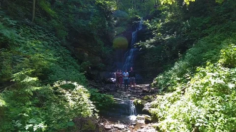 People are standing by the waterfall Stock Footage