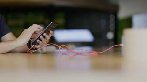 People are using charger for playing their phone Or smartphone in the service Vídeo Stock 146904662