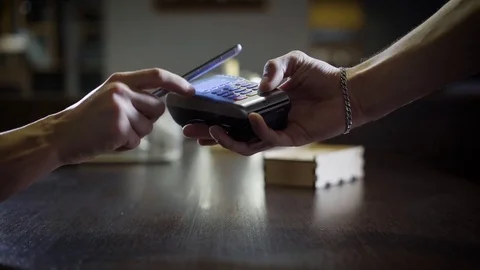 People are using contactless payment by phone in a restaurant, hand with Stock Footage