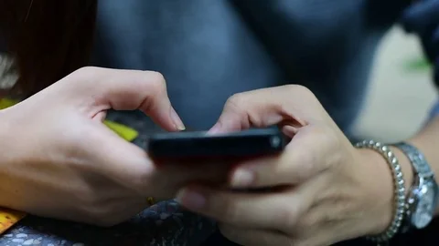 People are using a mobile phone to buy a product. And contact friends online.Peo Stock Footage 84246234