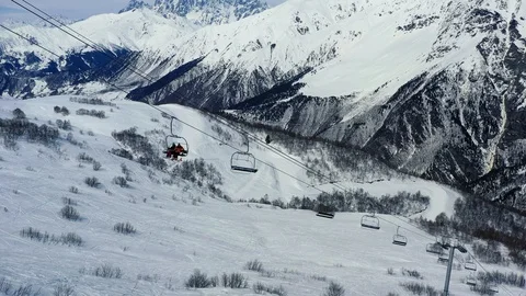 People are using a ski elevator to get to the top of a mountain, stunning Stock Footage 105783521