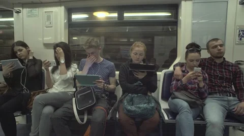 People Are Using Tablets While Riding A Metro Vídeo Stock 64897463