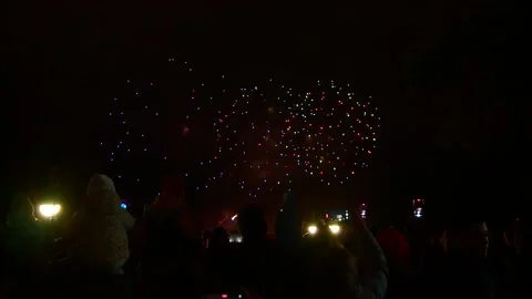 People are using their smartphones to capture fireworks in the night sky Stock Footage 335122650