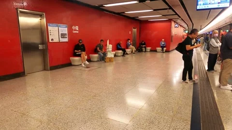 People are waiting for the train to arrive at Hong Kong Central Station. There Stock Footage 341699877