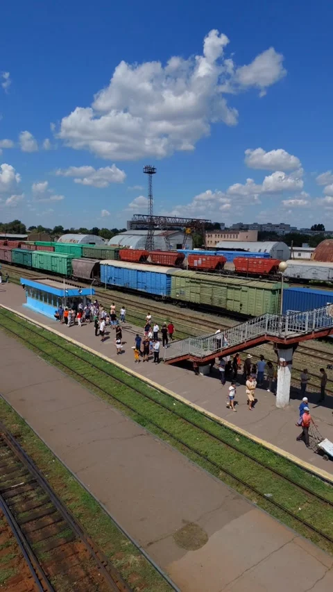 People are waiting for a train on the platform of the railway station Stock Footage 279996840