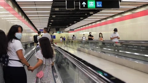 People are walking (or using moving walkway) in the MTR subway tunn Stock Footage 158096103