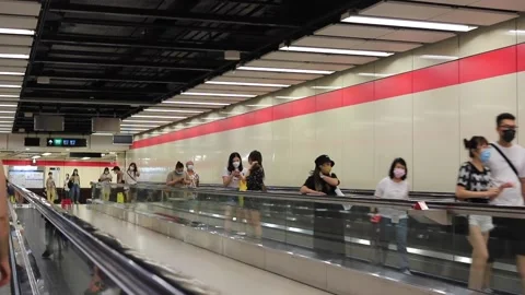 People are walking (or using moving walkway) in the MTR subway tunn Stock Footage 158096109