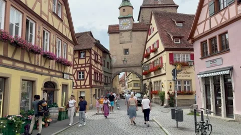People are walking through cobble stone street at Rothenburg ob der Tauber town Stock Footage 315669019
