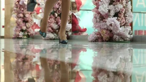 People are walking through a flower-lined avenue 3 Stock Footage 320501612