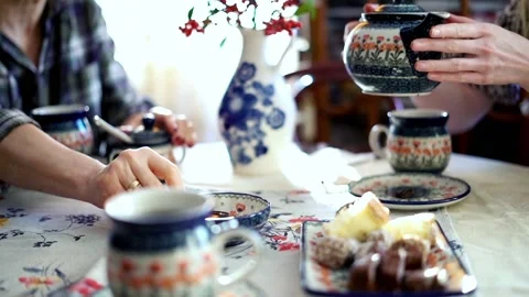 People around a table drinking tea focus on hands, 240fps Stock-Footage 96170056