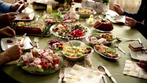 People around table during easter brekfast: focus on hands. Stock Footage 103996607