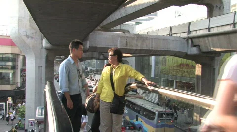 People arrive at the top of an escalator to enter the Metro in Bangkok Stock Footage 111645