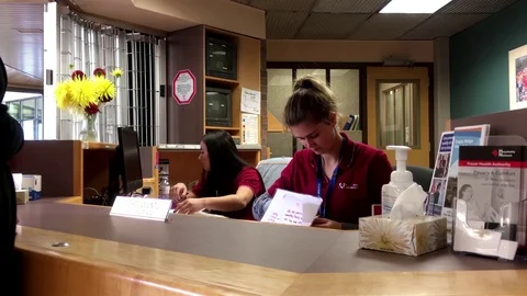 People asking direction at guest services counter Stock Footage 71697456