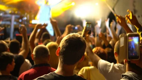 People in the audience with hands up having fun at a music concert Stock Footage 81261970