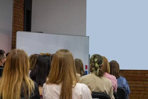 People in auditory during presentation or seminar. Teenagers or young men and 스톡 사진