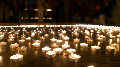 People in the Background Watching Burning Candles Stock Footage 64144397