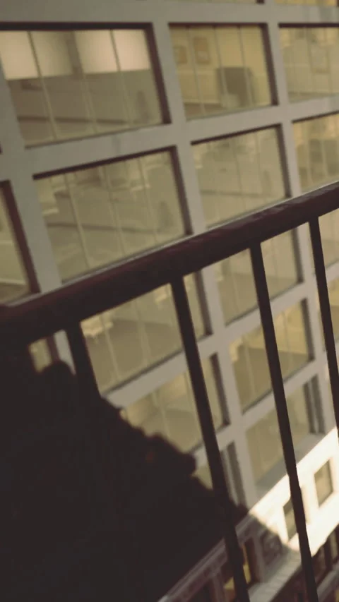 People on balcony with view of building windows at night Stock Footage 331688493