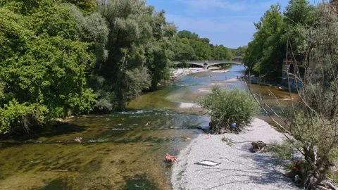 People by the banks of the cool Isar River, Munich Stock Footage 342340982