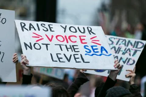 People with banners protest as part of a climate change march Stock Photos