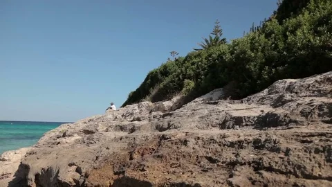 People bathe and rest on the beach. Spanish beaches in Cala Mendia. Mallorca Stock Footage 75550105