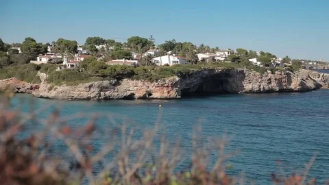 People bathe and rest on the beach. Spanish beaches in Cala Mendia. Mallorca Stock Footage 75555170