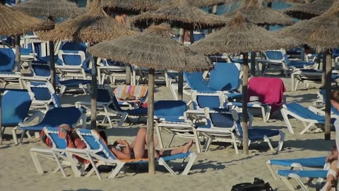 People bathe and rest on the beach. Spanish beaches in Cala Mendia. Mallorca Stock Footage 75591425