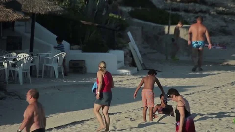 People bathe and rest on the beach. Spanish beaches in Cala Mendia. Mallorca Vídeo Stock 75593213