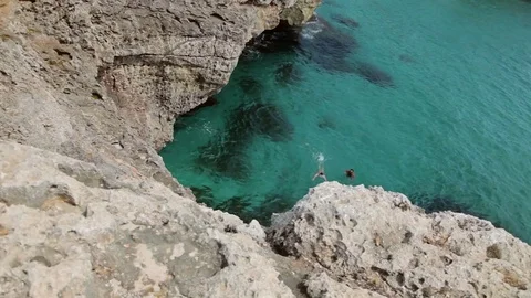 People bathe and rest on the beach. Spanish beaches in Cala Mendia. Mallorca Stock Footage 75610032