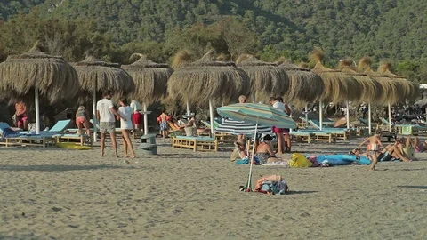 People bathe and rest on the beach. Spanish beaches in Mallorca Stock Footage 75618919