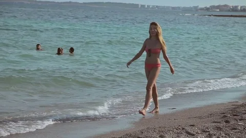 People bathe and rest on the beach. Spanish beaches in Mallorca Young girls in Stock Footage 75618988