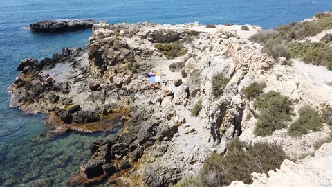 People bathing from the cliffs of the island of Tabarca Stockbeeldmateriaal 122219516